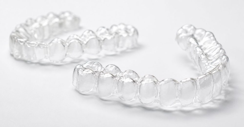 A pair of clear Invisalign aligners